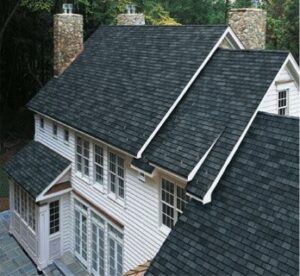 A top view of a house roof with green area around