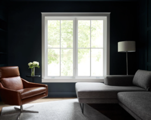 Living room with dark walls, furniture, and casement windows